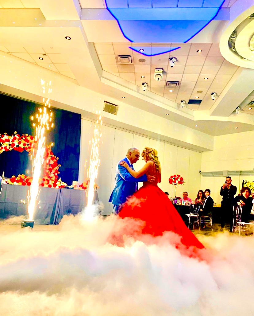 Father and daughter quinceañera dance with cold sparks and low fog
